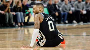 Milwaukee Bucks' Damian Lillard grimaces as he falls to the floor against the Indiana Pacers during the first half of Game 4 of a first-round NBA basketball playoff series Sunday, April 27, 2025, in Milwaukee. (AP Photo/Jeffrey Phelps)