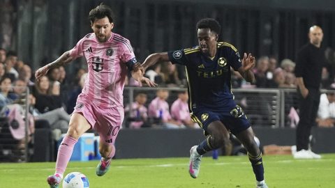 Inter Miami forward Lionel Messi, left, runs with the ball against Vancouver Whitecaps forward Ali Ahmed, right, during the first half of a CONCACAF Champions Cup second-leg semifinal soccer match, Wednesday, April 30, 2025, in Fort Lauderdale, Fla. (AP Photo/Lynne Sladky)