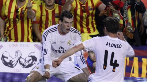 Real's Gareth Bale, left celebrates with Xabi Alonso after scoring his team's 2nd goal during the final of the Copa del Rey between FC Barcelona and Real Madrid at the Mestalla stadium in Valencia, Spain, Wednesday, April 16, 2014. (AP Photo/Alberto Saiz)