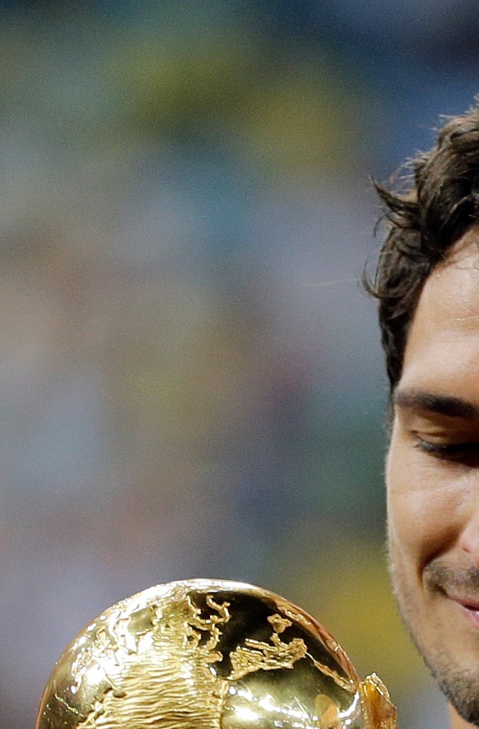 Germany's Mats Hummels holds the trophy after the World Cup final soccer match between Germany and Argentina at the Maracana Stadium in Rio de Janeiro, Brazil, Sunday, July 13, 2014. Germany won the match 1-0. (AP Photo/Matthias Schrader)