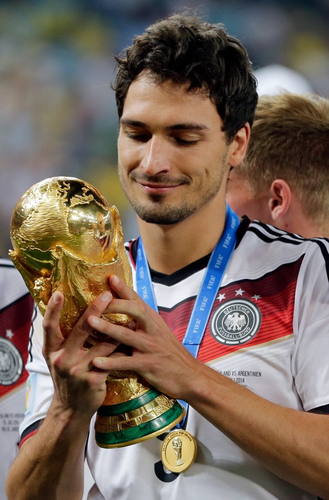 Germany's Mats Hummels holds the trophy after the World Cup final soccer match between Germany and Argentina at the Maracana Stadium in Rio de Janeiro, Brazil, Sunday, July 13, 2014. Germany won the match 1-0. (AP Photo/Matthias Schrader)