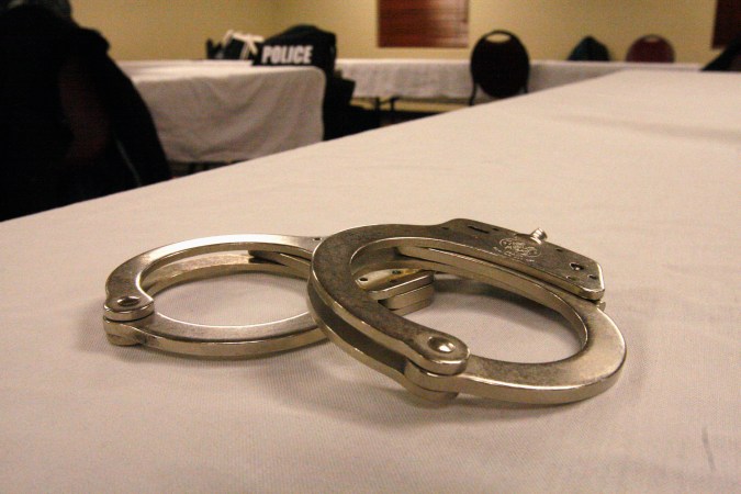 Handcuffs used on men arrested for prostitution solicitation sit on a table at a hotel in Minot, N.D., on Saturday, Jan. 31, 2015. Sex trafficking has become a big problem in North Dakota amid an oil boom that has brought in money and oil workers. The Minot police sting ended with the arrests of 13 men, who answered ads on an escort website posted by the undercover officers. (AP Photo/Martha Irvine)