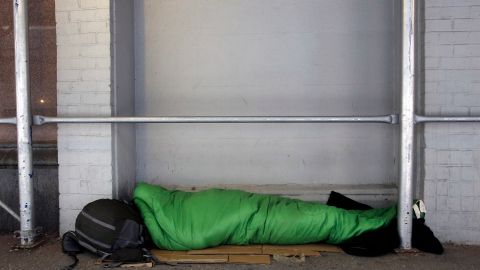 A homeless person sleeps in a sleeping bag on a New York sidewalk, Dec. 16, 2014 in New York. (AP Photo/Mark Lennihan)