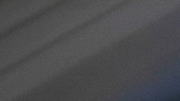 FILE - A woman looks at a hand held device on a train in New Jersey on May 18, 2021. (AP Photo/Jenny Kane, File)