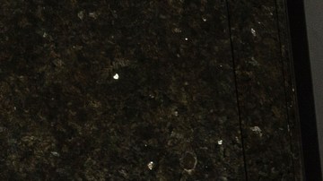 Workers clean the sidewalk of the closed Hollywood Pantages Theatre, as a homeless person sleeps under a blanket on the Hollywood Walk of Fame in Los Angeles on Tuesday, March 24, 2020. (AP Photo/Damian Dovarganes)