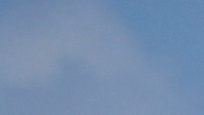 A surfer with a child walks on the mostly empty Santa Monica beach Sunday, March 29, 2020, in Los Angeles. With cases of coronavirus surging and the death toll increasing, lawmakers are pleading with cooped-up Californians to spend a second weekend at home to slow the spread of the infections. (AP Photo/Marcio Jose Sanchez)