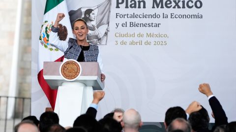 Mexican President Claudia Sheinbaum raises her fist as she speaks to national business leaders at the Anthropology Musuem in Mexico City, Thursday, April 3, 2025. (AP Photo/Fernando Llano)