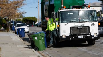 Waste Management employee Jim McNally collects garbage on a truck fueled by liquid natural gas in Castro Valley, Calif., Friday, Dec. 18, 2009. Hundreds of trash trucks across California are rumbling down city streets using clean fuel made from a dirty source: garbage. (AP Photo/Marcio Jose Sanchez)