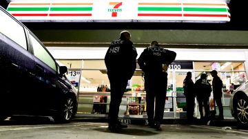 FILE - In this Wednesday, Jan. 10, 2018, file photo, U.S. Immigration and Customs Enforcement agents serve an employment audit notice at a 7-Eleven convenience store in Los Angeles. Orange County is considering two proposals to fight back against California's so-called sanctuary law for immigrants. The backlash to the state's effort to protect immigrants from stepped up deportations under the Trump administration comes a week after Los Alamitos voted to seek to exempt itself from the law. (AP Photo/Chris Carlson, File)