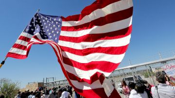 FILE - In this June 21, 2018 file photo, protesters and media gather outside a closed gate at the Port of Entry facility, where tent shelters are being used to house separated family members in Fabens, Texas. The tumult of the past week along the southern border crystalized how the GOP has shifted from the “compassionate” conservatism George W. Bush articulated to win the presidency twice, buoyed by the support of 44 percent of Latinos in 2004. Instead, wrenching photos and audio of the U.S. government separating migrant children from their parents symbolize the tense relationship between Latinos and the White House in the Trump era. (AP Photo/Matt York, File)