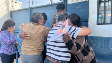 Los familiares de uno de los mineros asesinados en una mina de Pataz se abrazan a la salida de la morgue de Trujillo.