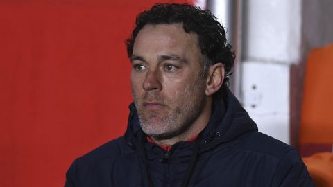 coach Gabriel Milito of Argentina's Argentinos Juniors sits on the bench prior to a Copa Libertadores round of 16 second leg soccer match against Argentina's River Plate in Buenos Aires, Argentina, Wednesday, July 21, 2021. (Marcelo Endelli/Pool via AP)