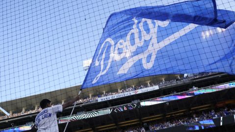 A Los Angeles Dodgers flag is waved before Game 2 of a baseball NL Division Series against the San Diego Padres, Wednesday, Oct. 12, 2022, in Los Angeles. (AP Photo/Ashley Landis)