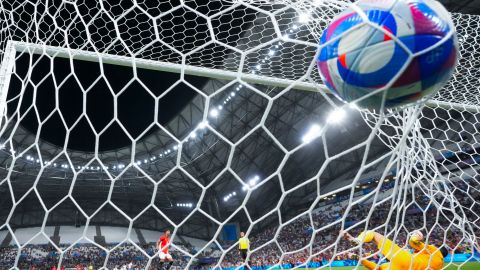A shot by Egypt's Hossam Abdelmaguid, left, enters the net of Paraguay goalkeeper Gatito Fernandez for a goal during a penalty kick shootout of a men's quarterfinal soccer match between Egypt and Paraguay at the 2024 Summer Olympics, Friday, Aug. 2, 2024, at Marseille Stadium in Marseille, France. Egypt won 5-4 (1-1) in penalty kicks. (AP Photo/Julio Cortez)