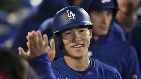 Los Angeles Dodgers' Hyeseong Kim, of South Korea, smiles as he celebrates after scoring against the Seattle Mariners during the third inning of a spring training baseball game Friday, March 7, 2025, in Peoria, Ariz. (AP Photo/Ross D. Franklin)