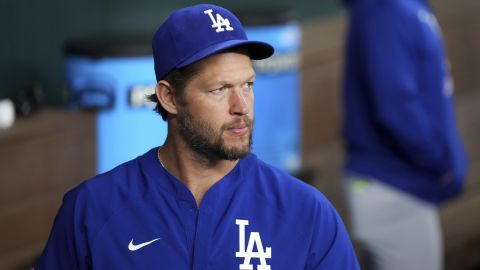 Los Angeles Dodgers starting pitcher Clayton Kershaw, who is on the 60-day injured list with a left toe injury, looks on from the dugout before a baseball game against the Texas Rangers, Saturday, April 19, 2025, in Arlington, Texas. (AP Photo/Jeffrey McWhorter)
