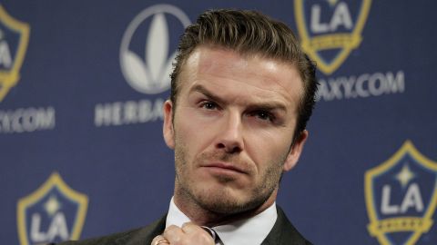 FILE - Los Angeles Galaxy's David Beckham fixes his tie during a news conference in Los Angeles, Jan. 19, 2012. (AP Photo/Jae C. Hong, File)