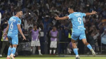 Angel Sepulveda of Mexico's Cruz Azul, right, celebrates scoring his side's opening goal from the penalty spot alongside Erik Lira against Mexico's Tigres during a CONCACAF Champions Cup second leg semifinal soccer match in Mexico City, Thursday, May 1, 2025. (AP Photo/Eduardo Verdugo)