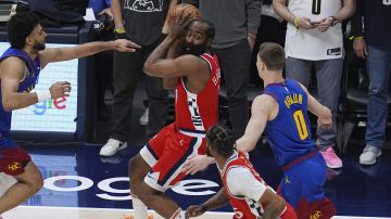 Los Angeles Clippers guard James Harden, top center, looks to pass the ball to forward Derrick Jones Jr., bottom center, as Denver Nuggets guards Jamal Murray, left, and Christian Braun (0) defend in the first half of Game 7 of an NBA basketball first-round playoff series Saturday, May 3, 2025, in Denver. (AP Photo/David Zalubowski)