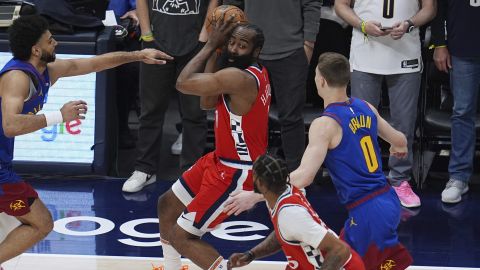 Los Angeles Clippers guard James Harden, top center, looks to pass the ball to forward Derrick Jones Jr., bottom center, as Denver Nuggets guards Jamal Murray, left, and Christian Braun (0) defend in the first half of Game 7 of an NBA basketball first-round playoff series Saturday, May 3, 2025, in Denver. (AP Photo/David Zalubowski)