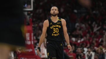 Golden State Warriors' Stephen Curry walks to the bench during the first half of Game 7 of an NBA basketball first-round playoff series Sunday, May 4, 2025, in Houston. (AP Photo/Ashley Landis)