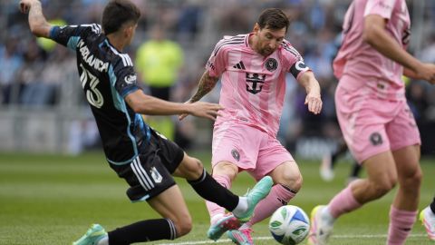 Inter Miami forward Lionel Messi (10) shoots the ball as Minnesota United defender Anthony Markanich (13) defends during the first half of an MLS soccer match Saturday, May 10, 2025, in St. Paul, Minn. (AP Photo/Abbie Parr)