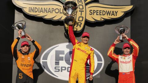 Alex Palou, of Spain, center, celebrates after winning the IndyCar Grand Prix auto race at Indianapolis Motor Speedway in Indianapolis, Saturday, May 10, 2025. Pato O'Ward, of Mexico, left, finished second and Will Power, of Australia, finished third. (AP Photo/Michael Conroy)