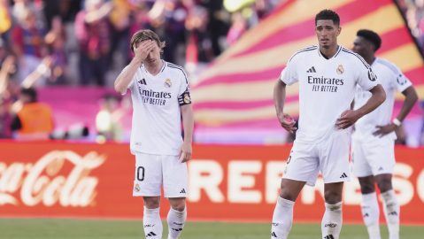 Real Madrid's Luka Modric, left, and Jude Bellingham react after Barcelona scoring a goal that was disallowed during the Spanish La Liga soccer match between Barcelona and Real Madrid at the Lluis Companys Olympic Stadium in Barcelona, Spain, Sunday, May 11, 2025. (AP Photo/Jose Breton)