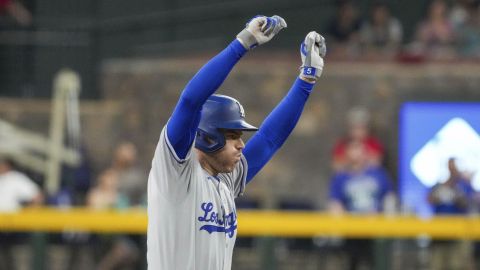 Los Angeles Dodgers' Freddie Freeman celebrates after hitting a double while scoring Mookie Betts against the Arizona Diamondbacks during the first inning of a baseball game Sunday, May 11, 2025, in Phoenix. (AP Photo/Darryl Webb)