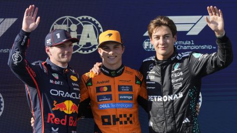 McLaren driver Oscar Piastri of Australia, centre, celebrates his pole position with second placed Red Bull driver Max Verstappen of the Netherlands, left, and Mercedes driver George Russell of Britain the qualifying session ahead of the Italy's Emilia Romagna Formula One Grand Prix, at the Enzo and Dino Ferrari racetrack in Imola, Italy, Saturday, May 17, 2025. (AP Photo/Luca Bruno)