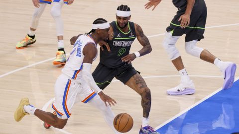 Oklahoma City Thunder guard Shai Gilgeous-Alexander, left, drives against his cousin Minnesota Timberwolves guard Nickeil Alexander-Walker during the first half of Game 1 of an NBA basketball Western Conference Finals playoff series Tuesday, May 20, 2025, in Oklahoma City. (AP Photo/Nate Billings)