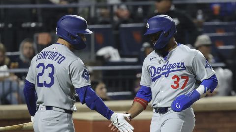Los Angeles Dodgers' Teoscar Hernández, right, reacts after scoring on a single hit by Andy Pages with Michael Conforto, left, during the fifth inning of a baseball game against the New York Mets, Friday, May 23, 2025, in New York. (AP Photo/Pamela Smith)