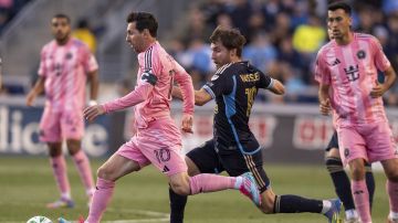 Inter Miami's Lionel Messi (10) dribbles as Philadelphia Union's Indiana Vassilev, center right, pursues during the first half of an MLS soccer match Saturday, May 24, 2025, in Chester, Pa.. (AP Photo/Chris Szagola)