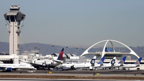 Airplanes sit on the tarmac at Los Angeles International Airport Friday, Nov. 1, 2013. Thousands of fliers were delayed Friday after a shooting in Terminal 3 closed parts of the airport for hours, prompting authorities to evacuate a terminal and stop flights headed for the city from taking off from other airports. Los Angeles police said a suspected gunman has been taken into custody. (AP Photo/Gregory Bull)