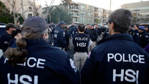 FILE - In this March 3, 2015 file photo, federal agents gather at a nearby parking lot before raiding an upscale apartment complex where authorities say a birth tourism business charged pregnant women $50,000 for lodging, food and transportation, in Irvine, Calif. On Thursday, Jan. 31, 2019, authorities announced they have charged 20 people in an unprecedented crackdown on businesses that helped hundreds of Chinese women travel to the United States to give birth to American citizen children. (AP Photo/Jae C. Hong, File)
