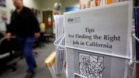 A job seeker walks by a job kiosk at a job placement center in Menlo Park, Calif., Wednesday, March 10, 2010. The number of newly laid-off workers requesting unemployment benefits fell last week, the latest sign the employment picture is slowly brightening.(AP Photo/Paul Sakuma)