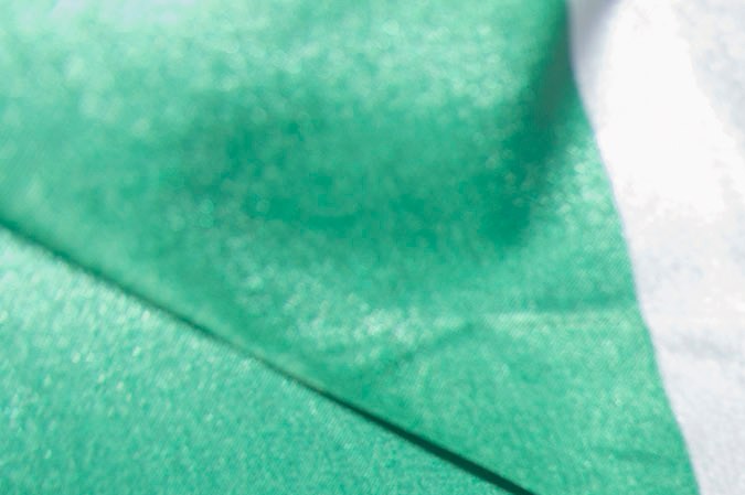 Kimberly Esparza walks draped in a Mexican flag during a protest against presidential candidate Donald Trump, Thursday, July 23, 2015, at Laredo International Airport in Laredo, Texas. (AP Photo/Darren Abate)