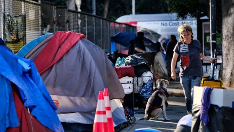 Homeless people move belongings from a street near Los Angeles City Hall as crews prepared to clean the area Monday, July 1, 2019. Los Angeles Mayor Eric Garcetti and a group of other city leaders from around California and the nation are backing the proposed Ending Homelessness Act. The legislation sponsored by U.S. Rep. Maxine Waters, D-Calif., would use more than $13 billion to the efforts of cities to deal with the homelessness crisis. (AP Photo/Richard Vogel)