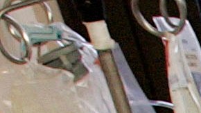 Dr. Richard Miller, right, the medical director of the trauma unit at Vanderbilt University Medical Center in Nashville, Tenn., performs surgery on a car crash victim with Dr. Jamie Bohl, chief resident, left, and procedure nurse Milton Higginbothem, center, on Tuesday, Aug. 8, 2006. Vanderbilt is one of two of the state's major trauma hospitals that are footing the bill for out-of-state patients who don't have to wear helmets when riding motorcycles. The hospital treats about 100 patients who suffer severe head injuries from motorcycle crashes each year, said Beth Broering, trauma coordinator at Vanderbilt. About 11 percent of those patients are from Kentucky, of whom 75 percent are uninsured. (AP Photo/Mark Humphrey)