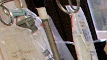 Dr. Richard Miller, right, the medical director of the trauma unit at Vanderbilt University Medical Center in Nashville, Tenn., performs surgery on a car crash victim with Dr. Jamie Bohl, chief resident, left, and procedure nurse Milton Higginbothem, center, on Tuesday, Aug. 8, 2006. Vanderbilt is one of two of the state's major trauma hospitals that are footing the bill for out-of-state patients who don't have to wear helmets when riding motorcycles. The hospital treats about 100 patients who suffer severe head injuries from motorcycle crashes each year, said Beth Broering, trauma coordinator at Vanderbilt. About 11 percent of those patients are from Kentucky, of whom 75 percent are uninsured. (AP Photo/Mark Humphrey)