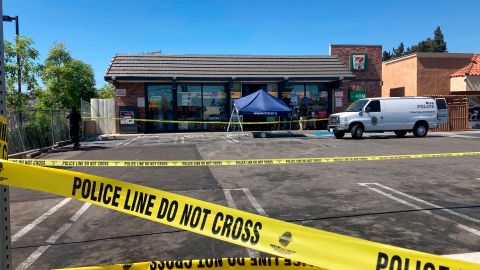 Police crime scene tape closes off a parking area following a shooting at a 7-Eleven store in Brea, Calif., on Monday, July 11, 2022. Police say two people have been killed and three have been wounded in pre-dawn shootings at four Southern California 7-Eleven stores. Authorities said Monday that at least three of the four shootings are believed to be linked to the same lone gunman. (AP Photo/Eugene Garcia)