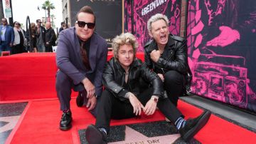 Tré Cool (izquierda), Billie Joe Armstrong y Mike Dirnt, de Green Day, posan con su nueva estrella durante una ceremonia en el Paseo de la Fama de Hollywood el jueves 1 de mayo de 2025, en Los Ángeles. (Foto AP/Chris Pizzello)
