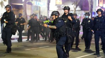 A police officer prepares to fire rubber bullets during a protest over the death of George Floyd Friday, May 29, 2020, in Los Angeles. Floyd died in police custody Monday in Minneapolis. (AP Photo/Ringo H.W. Chiu)