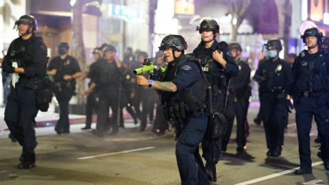 A police officer prepares to fire rubber bullets during a protest over the death of George Floyd Friday, May 29, 2020, in Los Angeles. Floyd died in police custody Monday in Minneapolis. (AP Photo/Ringo H.W. Chiu)