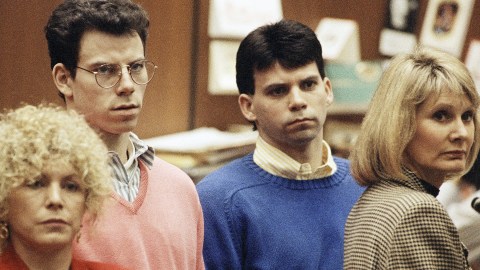 Lyle Menendez, right, and brother Erik listen to a charge of murder conspiracy against them with Leslie Abramson, far left, attorney for Erik, Dec. 29, 1992 in Los Angeles. The brothers pled innocent to the new indictment which dropped the original charge that they killed their parents for money. The indictment was returned nearly three years after Joseph and Kitty Menendez were found slain in their home. (AP Photo/Chris Martinez)