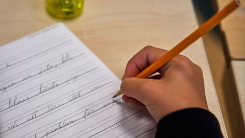 A child practices handwriting at the Djurgardsskolan elementary school in Stockholm, Sweden, Thursday, Aug. 31, 2023. As children across Sweden have recently flocked back to school after the summer vacation, many of their teachers are putting a new emphasis on printed books, quiet reading hours, and practicing handwriting as the country's yearslong focus on the digitalization of classrooms has come under scrutiny. (AP Photo/David Keyton)