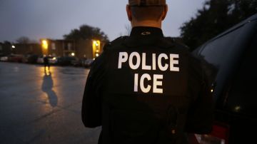 FILE - In this March 6, 2015, file photo, U.S. Immigration and Customs Enforcement agents enter an apartment complex looking for a specific undocumented immigrant convicted of a felony during an early morning operation in Dallas. The federal government provided Tuesday, Dec. 5, 2017, the most complete statistical snapshot of immigration enforcement under President Donald Trump, showing Border Patrol arrests plunged to a 45-year low while arrests by deportation officers soared. (AP Photo/LM Otero, File)