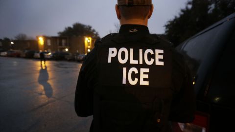FILE - In this March 6, 2015, file photo, U.S. Immigration and Customs Enforcement agents enter an apartment complex looking for a specific undocumented immigrant convicted of a felony during an early morning operation in Dallas. The federal government provided Tuesday, Dec. 5, 2017, the most complete statistical snapshot of immigration enforcement under President Donald Trump, showing Border Patrol arrests plunged to a 45-year low while arrests by deportation officers soared. (AP Photo/LM Otero, File)