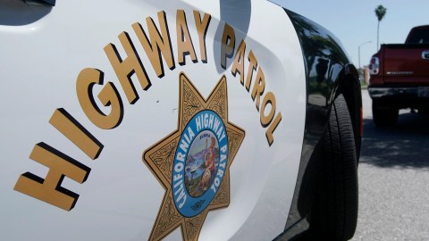 FILE - In this April 23, 2020, file photo, a California Highway Patrol officer stops a motorist in Anaheim, Calif. California Attorney General Rob Bonta announced, Thursday, July 8, 2021, that six officers working out of East Los Angeles, have been criminally charged for exaggerating their overtime hours while providing protection for state highway workers during road construction projects. (AP Photo/Chris Carlson, File)
