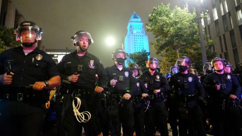 In this May 29, 2020, photo, police officers stand guard near the City Hall during a protest over the death of George Floyd in Los Angeles. Floyd died in police custody Monday in Minneapolis. (AP Photo/Ringo H.W. Chiu)